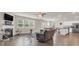 Open-concept living space features a fireplace, large windows, and a kitchen with stainless steel appliances at 4323 Cannon Walk, Ellenwood, GA 30294