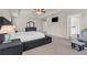 Spacious primary bedroom with tray ceiling, carpet floor, and sitting area at 4323 Cannon Walk, Ellenwood, GA 30294
