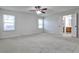 This bedroom has a ceiling fan, neutral carpet, and an ensuite bathroom at 52 Sutton Pl, Avondale Estates, GA 30002