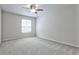 This bedroom has soft carpet and a ceiling fan at 52 Sutton Pl, Avondale Estates, GA 30002