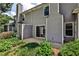 Back exterior view of the house with sliding glass door and patio, surrounded by lush greenery at 52 Sutton Pl, Avondale Estates, GA 30002