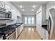 Bright kitchen boasts stainless steel appliances, hardwood floors, and a view to the breakfast nook at 52 Sutton Pl, Avondale Estates, GA 30002