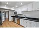 Kitchen features stainless steel appliances, white cabinets, and hardwood floors at 52 Sutton Pl, Avondale Estates, GA 30002