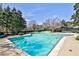 Inviting community pool featuring clear blue water, mature trees, and plenty of space for relaxation and recreation at 52 Sutton Pl, Avondale Estates, GA 30002