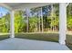 View from the covered patio highlighting the grassy backyard and serene natural surroundings at 779 Keystone Dr, Woodstock, GA 30188