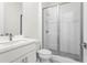 Modern bathroom with a glass-enclosed shower, a single vanity, and sleek fixtures and finishes at 779 Keystone Dr, Woodstock, GA 30188