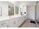Bathroom with long double sink vanity with white countertop and sleek fixtures and hardware at 779 Keystone Dr, Woodstock, GA 30188