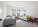 Bright bedroom with two beds, shelving, and sunny windows at 779 Keystone Dr, Woodstock, GA 30188