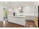 Bright kitchen with an island, plenty of cabinets, stainless steel appliances, and hardwood floors at 779 Keystone Dr, Woodstock, GA 30188