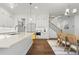 Spacious kitchen featuring white cabinetry, an island, and a combined dining area at 779 Keystone Dr, Woodstock, GA 30188