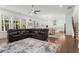 Spacious living room with hardwood floors, many windows, and an open floor plan to a modern kitchen at 779 Keystone Dr, Woodstock, GA 30188