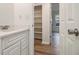 Bathroom featuring a white vanity with shelving and an open doorway at 1150 Collier Nw Rd # A1, Atlanta, GA 30318