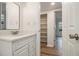 Bathroom with wood-look floors, white vanity and an adjacent storage closet at 1150 Collier Nw Rd # A1, Atlanta, GA 30318