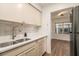 Bright kitchen featuring white cabinets, modern countertops, and a view of a well lit space at 1150 Collier Nw Rd # A1, Atlanta, GA 30318