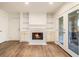 Cozy living room with hardwood floors, a charming fireplace, and French doors for outdoor access at 1150 Collier Nw Rd # A1, Atlanta, GA 30318