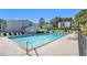 Community pool surrounded by lounge chairs and lush landscaping at 1150 Collier Nw Rd # A1, Atlanta, GA 30318