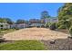 Sandy volleyball court surrounded by green grass and mature trees ready for outdoor community fun at 1150 Collier Nw Rd # A1, Atlanta, GA 30318