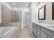 Modern bathroom with a glass-enclosed shower, a soaking tub, and double vanities at 5440 Howington Ct # 190, Buford, GA 30518