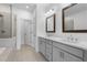Modern bathroom with a glass-enclosed shower, a soaking tub, and double vanities at 5440 Howington Ct # 190, Buford, GA 30518