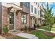 Inviting townhome entrance with brick facade, covered entryway, and manicured landscaping at 5440 Howington Ct # 190, Buford, GA 30518