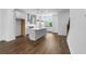 Open-concept kitchen with white cabinets, stainless steel appliances, and island at 5440 Howington Ct # 190, Buford, GA 30518