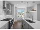 Modern kitchen with stainless steel appliances, quartz countertop, and subway tile backsplash at 5440 Howington Ct # 190, Buford, GA 30518