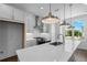 Bright kitchen features quartz countertops, stainless steel appliances, subway tile backsplash, and modern pendant lighting at 5440 Howington Ct # 190, Buford, GA 30518