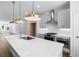 Well-lit kitchen featuring a large island with sink, stainless steel appliances, and open floor plan at 5440 Howington Ct # 190, Buford, GA 30518