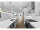 Modern kitchen featuring stainless steel appliances, a white quartz countertop island, and an open floor plan at 5440 Howington Ct # 190, Buford, GA 30518