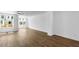 Bright, open-concept living room with hardwood floors and ample natural light from large windows at 5440 Howington Ct # 190, Buford, GA 30518