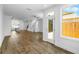 Open-concept living room with hardwood floors and white walls, with the kitchen visible in the background at 5440 Howington Ct # 190, Buford, GA 30518