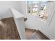 Staircase featuring hardwood floors and a large window overlooking the neighborhood at 5440 Howington Ct # 190, Buford, GA 30518