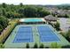 An aerial view showcasing the community's tennis courts and pool, surrounded by well-kept homes at 7410 Ansley View Ln, Cumming, GA 30028