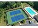 An aerial view highlighting tennis courts, swimming pool, playground, and parking at 7410 Ansley View Ln, Cumming, GA 30028