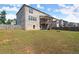 View of the home's backyard with a brick exterior, wooden fence, and a covered deck with stair access at 7410 Ansley View Ln, Cumming, GA 30028