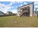 Large backyard with a wooden deck and a view of the multi-story home at 7410 Ansley View Ln, Cumming, GA 30028