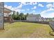 Large backyard with a wooden fence, deck and stairs leading down from the rear of this two story suburban home at 7410 Ansley View Ln, Cumming, GA 30028