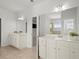 Bright bathroom featuring double vanities, tiled floors and modern lighting at 7410 Ansley View Ln, Cumming, GA 30028