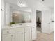 Bright bathroom with white cabinets, a large mirror, and a walk-in shower at 7410 Ansley View Ln, Cumming, GA 30028