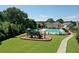 Enjoy the community pool and playground surrounded by lush green space and well-maintained landscaping at 7410 Ansley View Ln, Cumming, GA 30028