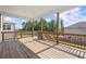 Covered wooden deck with a view of the backyard and neighborhood at 7410 Ansley View Ln, Cumming, GA 30028