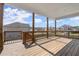 Covered wooden deck with view of backyard and houses in the neighborhood at 7410 Ansley View Ln, Cumming, GA 30028