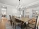 Elegant dining room featuring a chandelier, neutral colors, and stylish decor at 7410 Ansley View Ln, Cumming, GA 30028