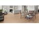 Open-concept dining area with table set for four, bathed in natural light, with views to a comfortable living space at 7410 Ansley View Ln, Cumming, GA 30028