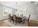Dining room features a chandelier, large window, and a dining table with six chairs at 7410 Ansley View Ln, Cumming, GA 30028