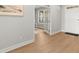Bright entryway with hardwood floors leading to a doorway with french doors and a white door at 7410 Ansley View Ln, Cumming, GA 30028