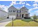 Beautiful two-story brick home featuring a two-car garage and manicured front yard at 7410 Ansley View Ln, Cumming, GA 30028