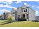 Suburban home featuring a stone and brick exterior, well-manicured lawn and a neatly landscaped front yard at 7410 Ansley View Ln, Cumming, GA 30028