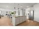Spacious kitchen island with granite countertop adjacent to dining area and featuring modern stainless steel refrigerator at 7410 Ansley View Ln, Cumming, GA 30028