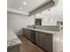 Open-concept kitchen features granite countertops and sleek, gray cabinets at 7410 Ansley View Ln, Cumming, GA 30028